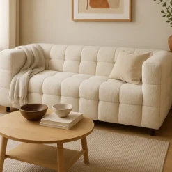 Canapé double capitonné en tissu bouclette beige